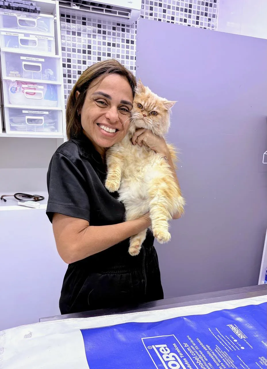 Dra. Caroline Keffer sorrindo com um gato persa no colo